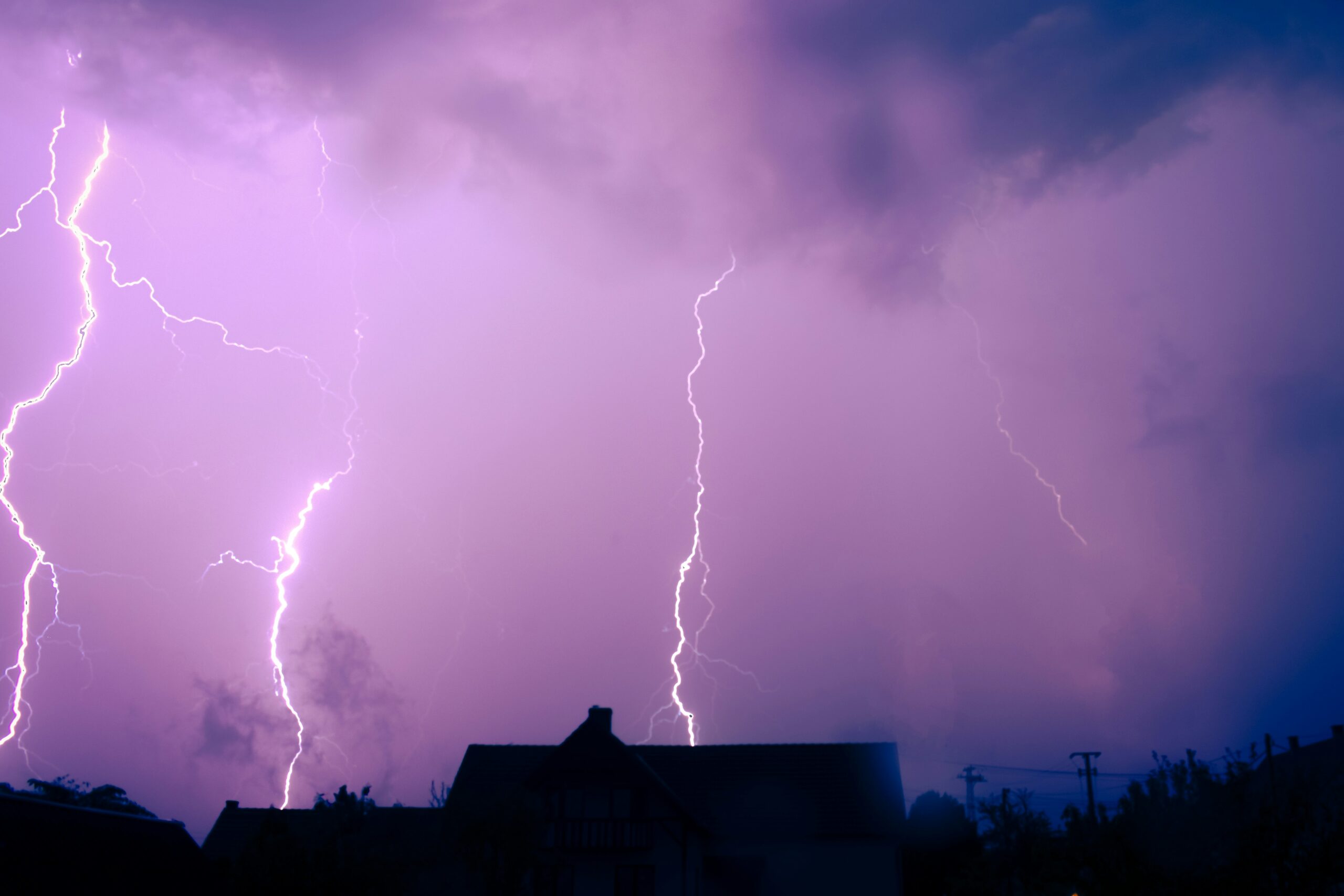 A lightning storm is seen over a residential area