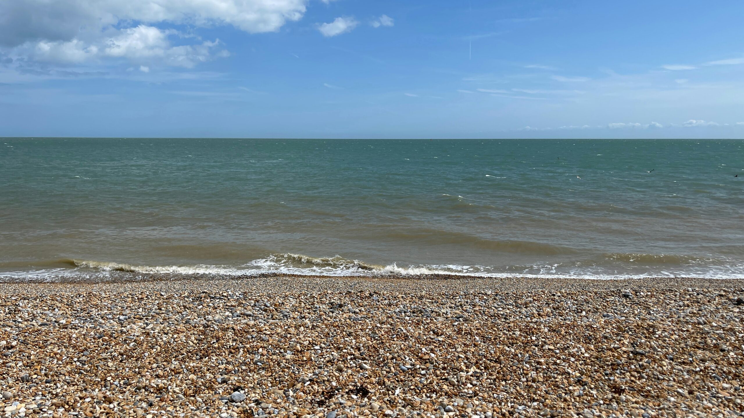 A view of the ocean from a sandy beach