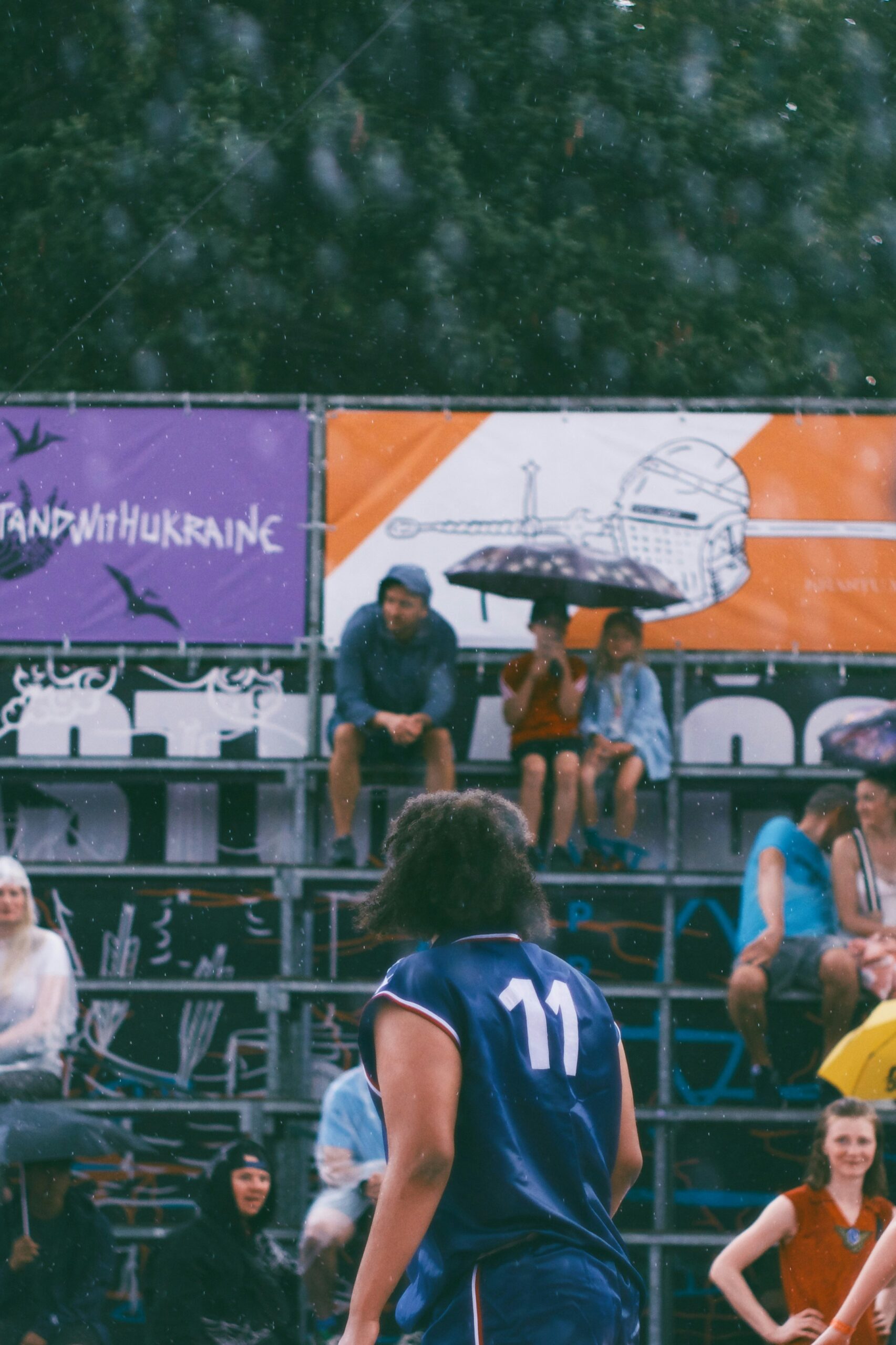 A group of people playing a game of basketball